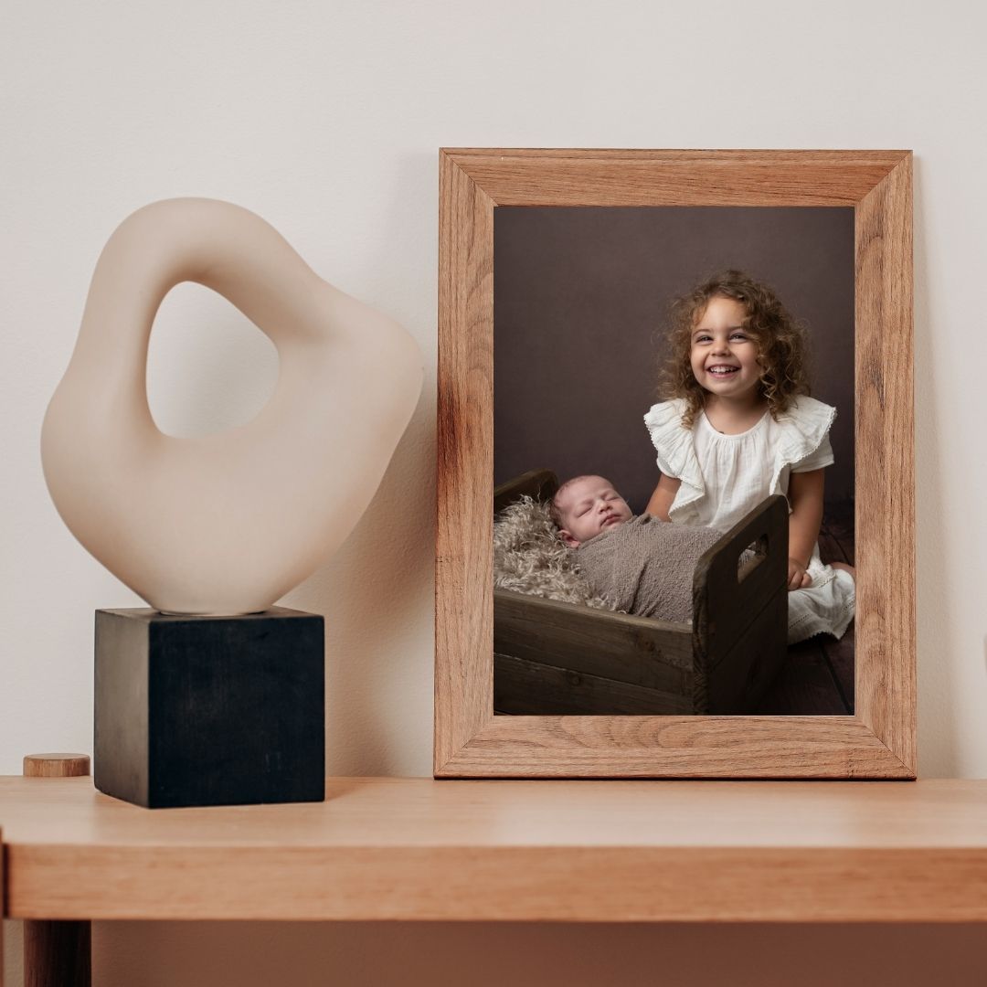 Framed 8 inch desktop portrait of a girl with her newborn sibling