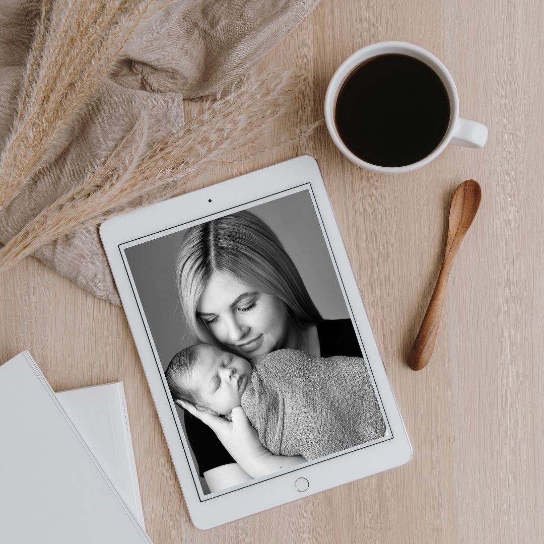 Black and white portrait of a mother and newborn on a tablet