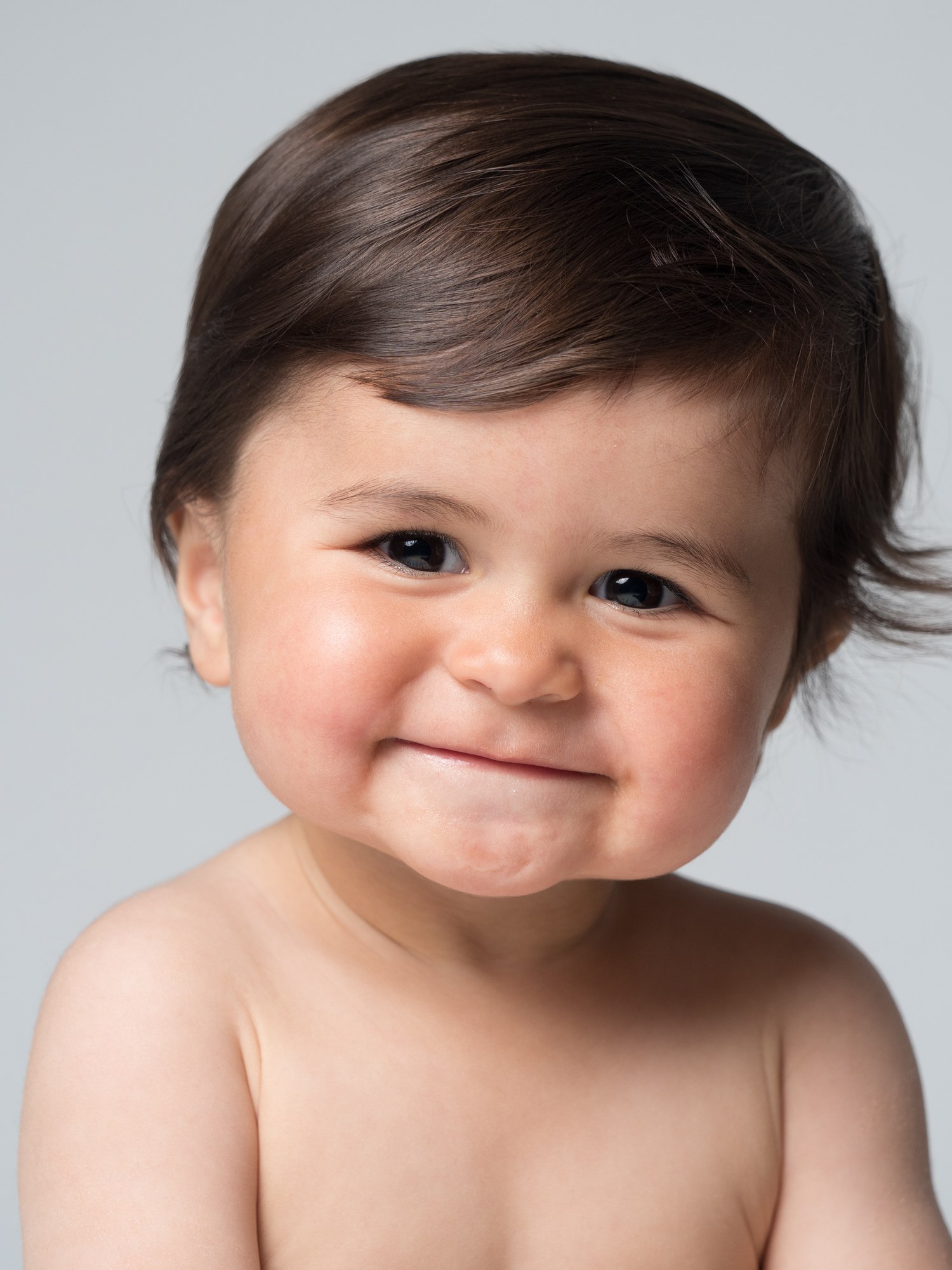 Smiling baby sitting in the studio