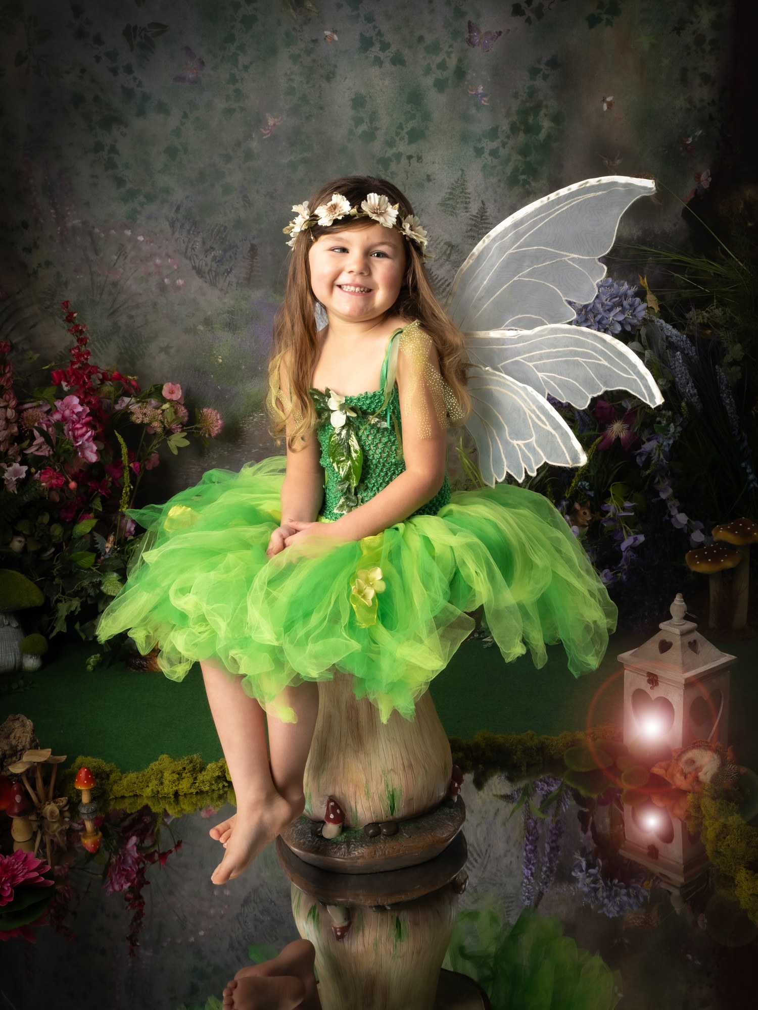 Smiling fairy in a green tutu on a toadstool