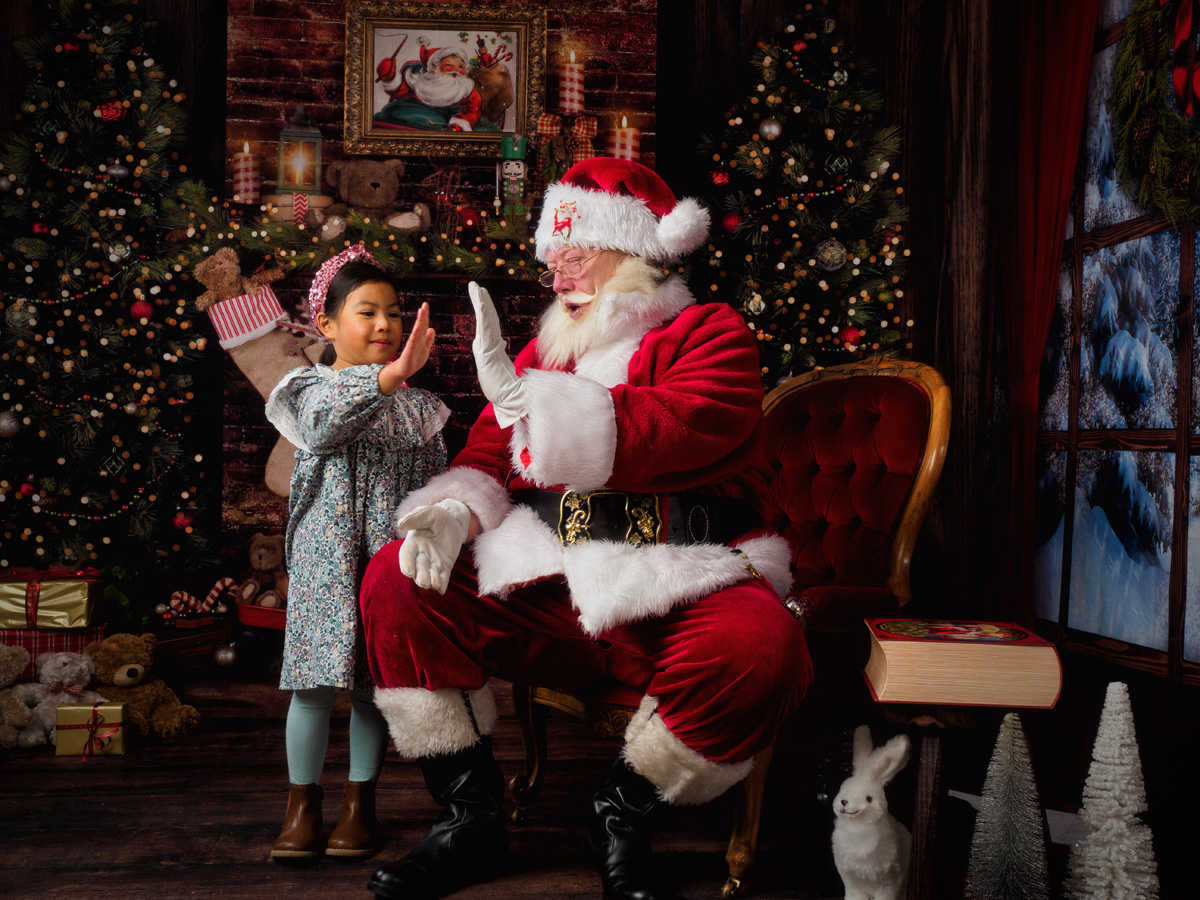 Little girl giving Santa a high five